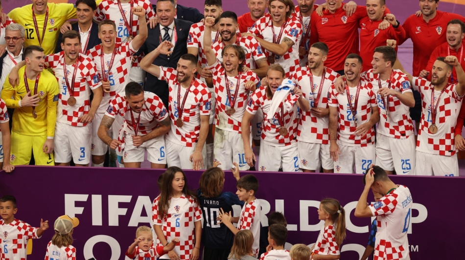 Croatia's players celebrate after winning the Qatar 2022 World Cup football third place play-off match at Khalifa International Stadium in Doha on December 17, 2022. (Photo by ADRIAN DENNIS / AFP)